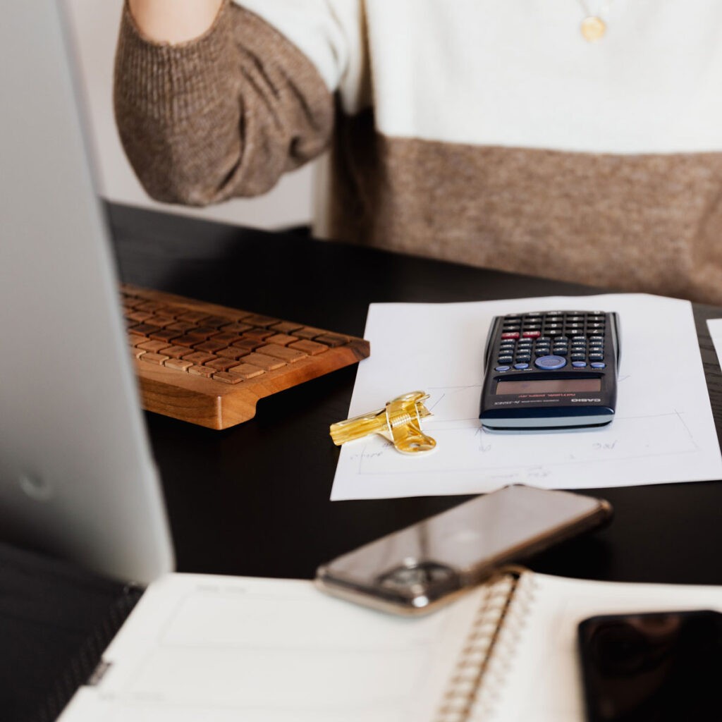 Woman with calculator and paperwork